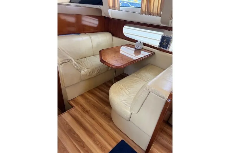 Slide: The Image of Luxurious interior of 2004 Carver 466 Motor Yacht with elegant wood finishes and anchor-themed rug. - 60