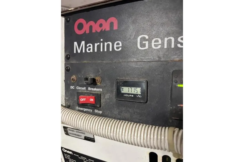 Slide: The Image of Onan generator panel on 2004 Carver 466 Motor Yacht, showing specifications and warnings. - 88