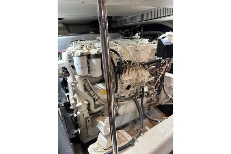 Slide: The Image of Engine compartment of a 2004 Carver 466 Motor Yacht, featuring hoses and mechanical components. - 95