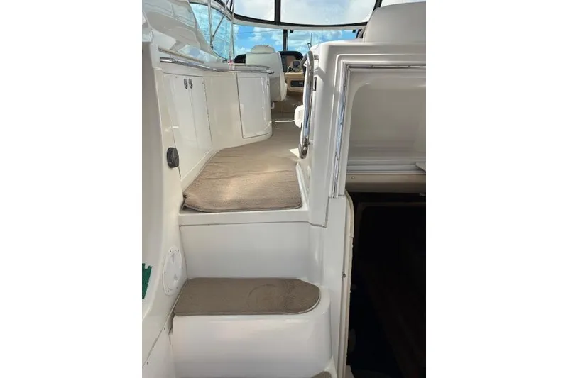 Slide: The Image of Interior of 2004 Carver 466 Motor Yacht with seating and wooden table. - 18