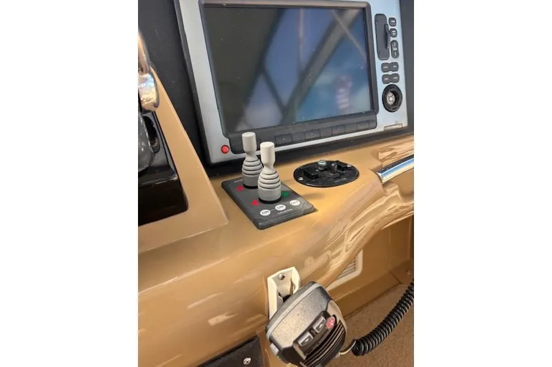 Slide: The Image of 2004 Carver 466 Motor Yacht helm with navigation controls and communication equipment. - 24