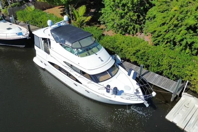 Slide: The Image of 2004 Carver 466 Motor Yacht docked by lush greenery, aerial view. - 3