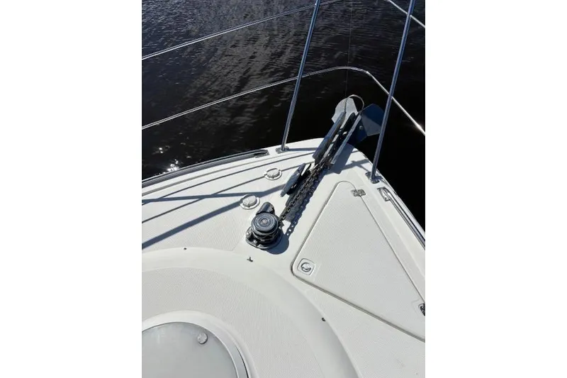Slide: The Image of Bow view of 2004 Carver 466 Motor Yacht approaching a bridge on a sunny day. - 31