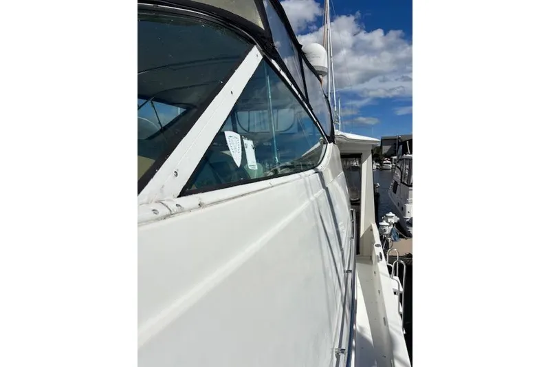 Slide: The Image of 2004 Carver 466 Motor Yacht docked at marina, side view with clear sky. - 36