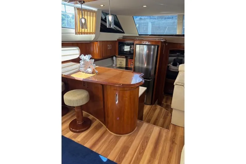Slide: The Image of Interior of 2004 Carver 466 Motor Yacht with elegant wood and leather furnishings. - 42