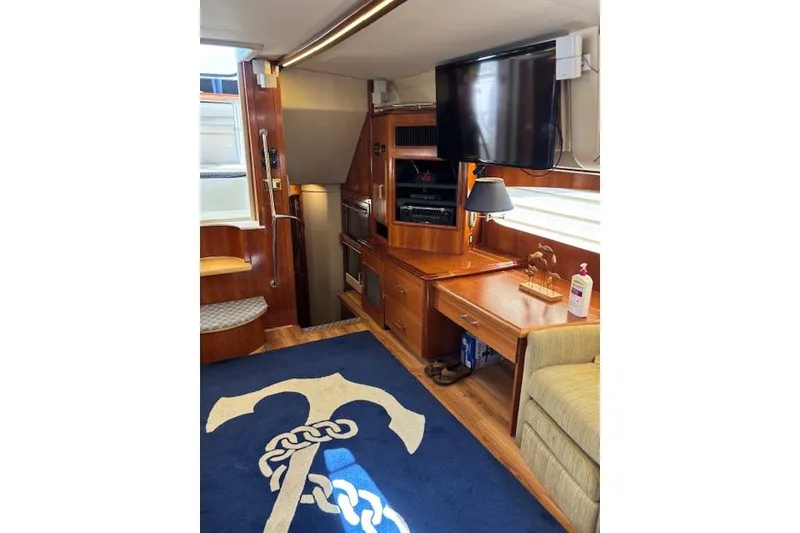 Slide: The Image of Interior of 2004 Carver 466 Motor Yacht with cozy seating and entertainment area. - 44