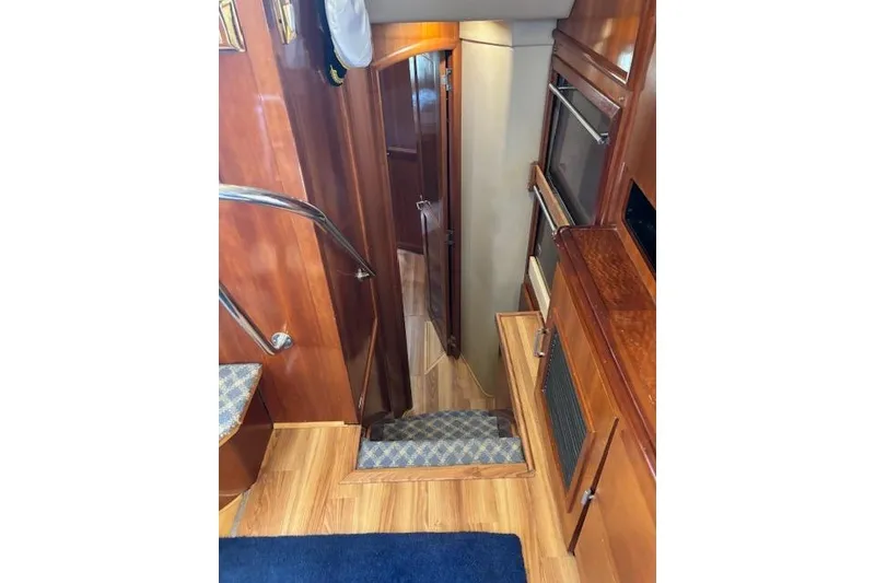 Slide: The Image of Luxurious interior of 2004 Carver 466 Motor Yacht with TV and nautical decor. - 45