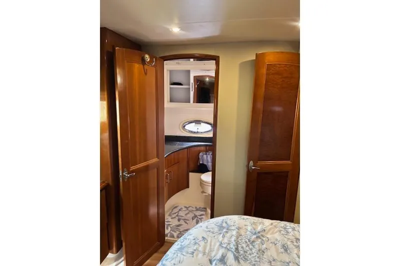 Slide: The Image of Interior of 2004 Carver 466 Motor Yacht with wooden cabinetry and cozy decor. - 48