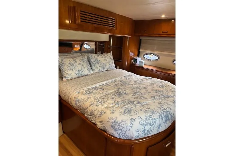 Slide: The Image of Luxurious bedroom interior of 2004 Carver 466 Motor Yacht with floral bedding. - 55