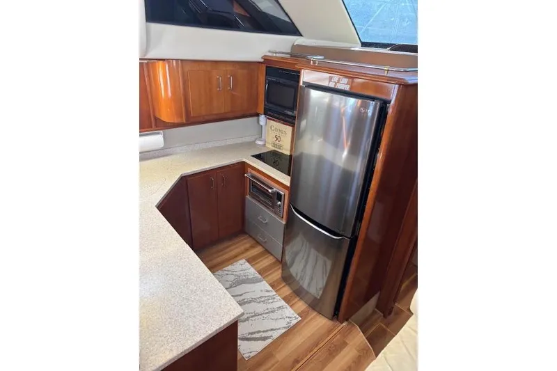 Slide: The Image of 2004 Carver 466 Motor Yacht interior with leather seating and wooden table. - 61