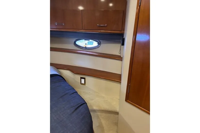 Slide: The Image of Storage area inside 2004 Carver 466 Motor Yacht with shelves and cleaning equipment. - 75