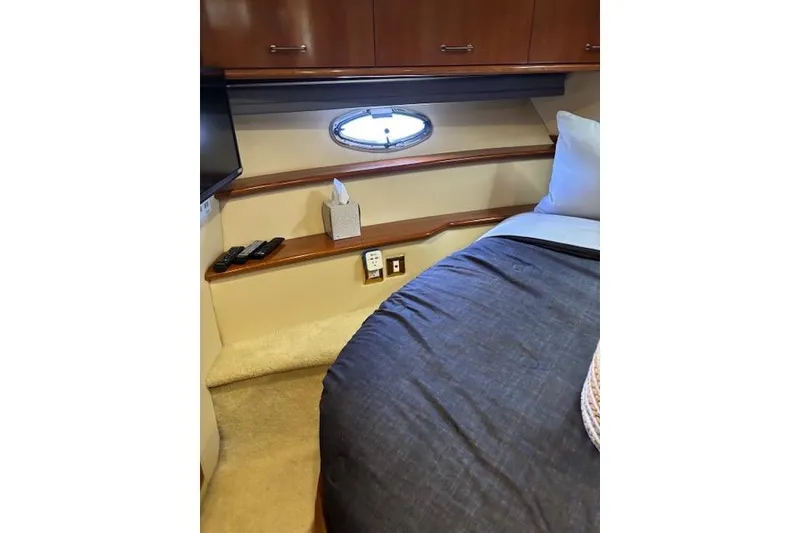 Slide: The Image of Interior of 2004 Carver 466 Motor Yacht with wood cabinetry and porthole window. - 76