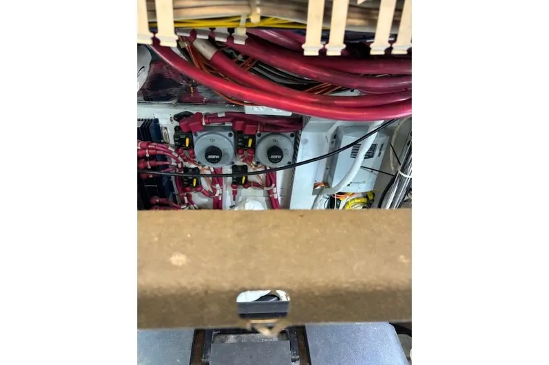 Slide: The Image of Engine room of 2004 Carver 466 Motor Yacht, showcasing mechanical components and wiring. - 80