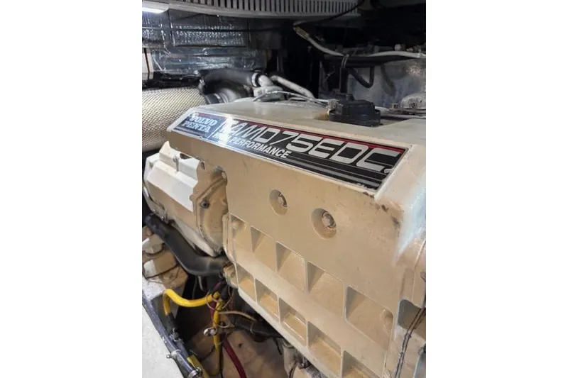 Slide: The Image of Engine room of 2004 Carver 466 Motor Yacht with visible fuel filter and hoses. - 93