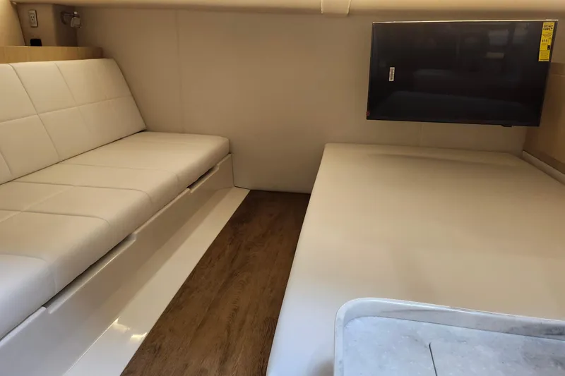 Slide: The Image of 2026 Regal 38 SAV interior with white seating, wood flooring, and mounted TV. - 23