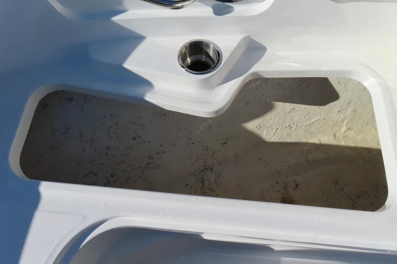 Slide: The Image of 2021 Hurricane SunDeck Sport 185 OB boat interior detail with cup holder and storage compartment. - 11