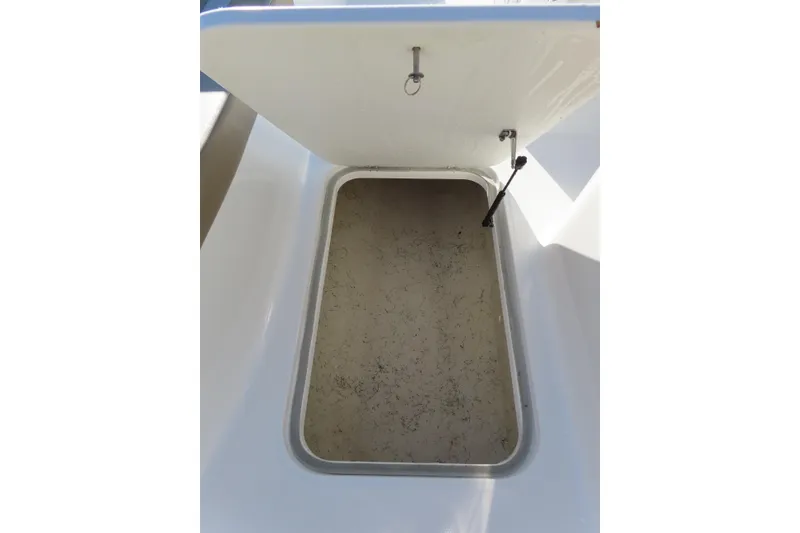 Slide: The Image of Open storage compartment on 2021 Hurricane SunDeck Sport 185 OB boat. - 14