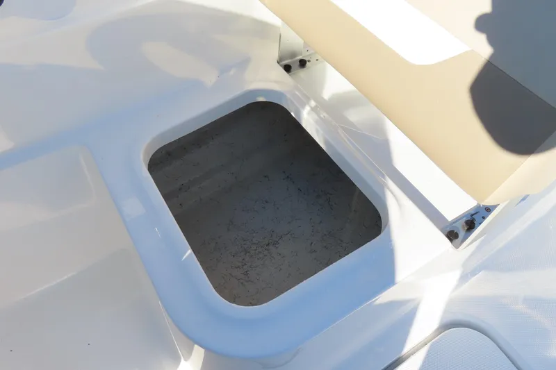 Slide: The Image of 2021 Hurricane SunDeck Sport 185 OB boat storage compartment with beige seating. - 19