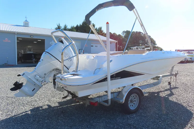 Slide: The Image of 2021 Hurricane SunDeck Sport 185 OB boat on trailer, parked outside dealership. - 2