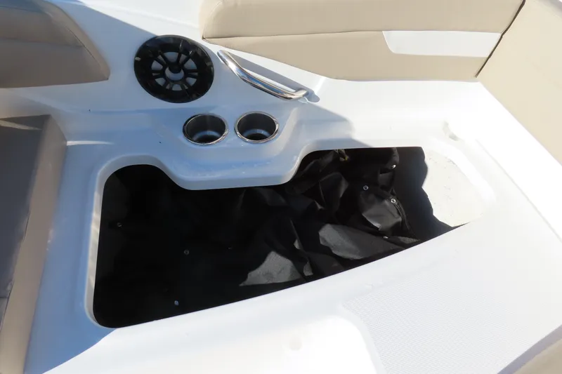 Slide: The Image of 2021 Hurricane SunDeck Sport 185 OB boat interior with cup holders and storage compartment. - 26