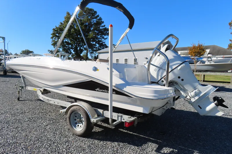 Slide: The Image of 2021 Hurricane SunDeck Sport 185 OB boat on trailer, parked outdoors. - 3