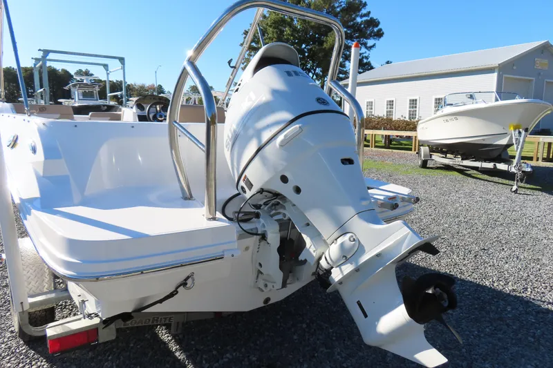 Slide: The Image of 2021 Hurricane SunDeck Sport 185 OB boat with outboard motor, parked on gravel. - 4