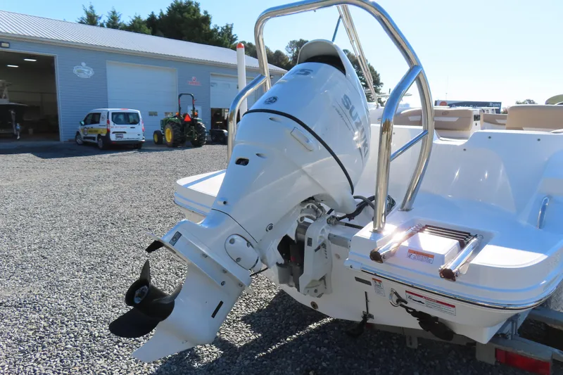 Slide: The Image of 2021 Hurricane SunDeck Sport 185 OB boat with Suzuki outboard motor in a marina setting. - 5