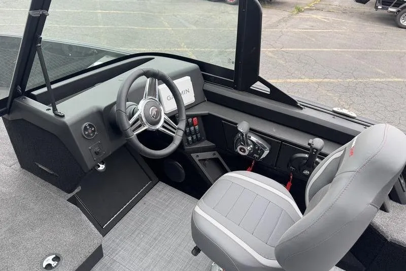 Slide: The Image of Interior of 2025 Alumacraft Competitor 205X Sport boat with steering wheel and controls. - 4