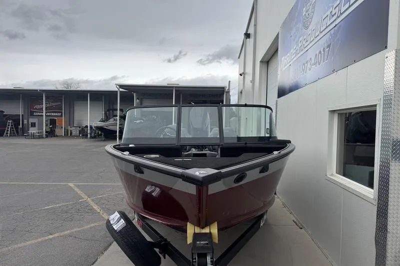 Slide: The Image of 2025 Alumacraft Competitor 205X Sport boat on trailer outside dealership. - 6
