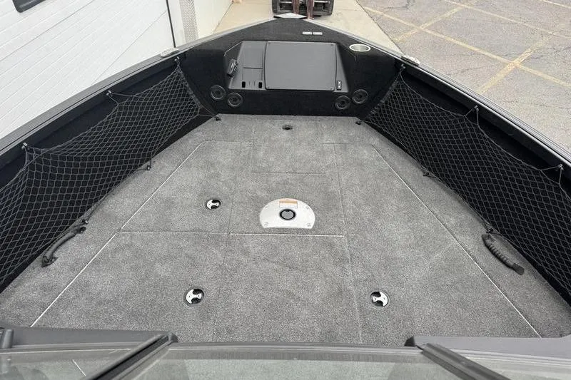 Slide: The Image of 2025 Alumacraft Competitor 205X Sport boat interior with storage compartments and netting. - 8