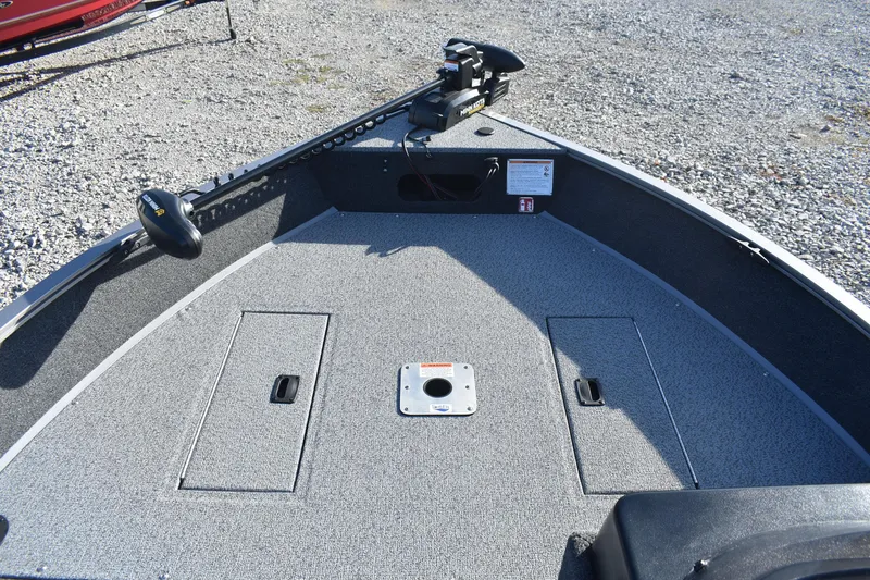 Slide: The Image of 2026 Lowe Fishing Machine 1675SC boat deck with storage compartments and trolling motor. - 11