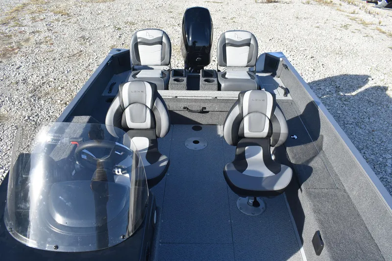 Slide: The Image of 2026 Lowe Fishing Machine 1675SC boat interior with seating and steering console. - 12