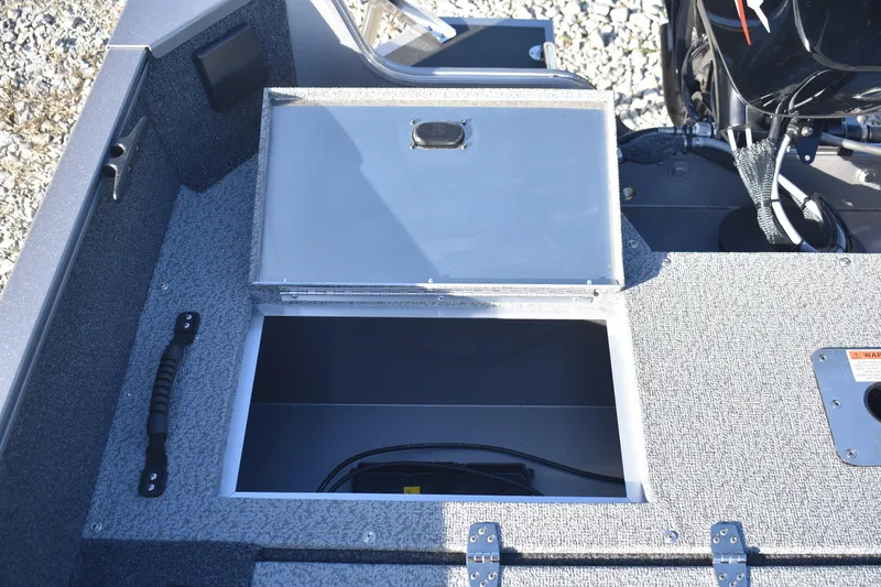 Slide: The Image of 2026 Lowe Fishing Machine 1675SC boat storage compartment with open lid. - 16