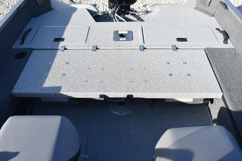 Slide: The Image of 2026 Lowe Fishing Machine 1675SC boat interior with storage compartments and seating. - 17