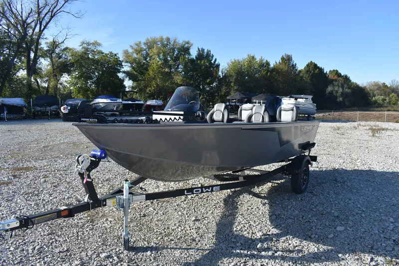 Slide: The Image of 2026 Lowe Fishing Machine 1675SC boat on trailer in outdoor setting. - 2