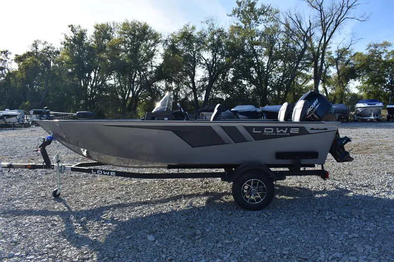 Slide: The Image of 2026 Lowe Fishing Machine 1675SC boat on trailer, parked outdoors. - 3