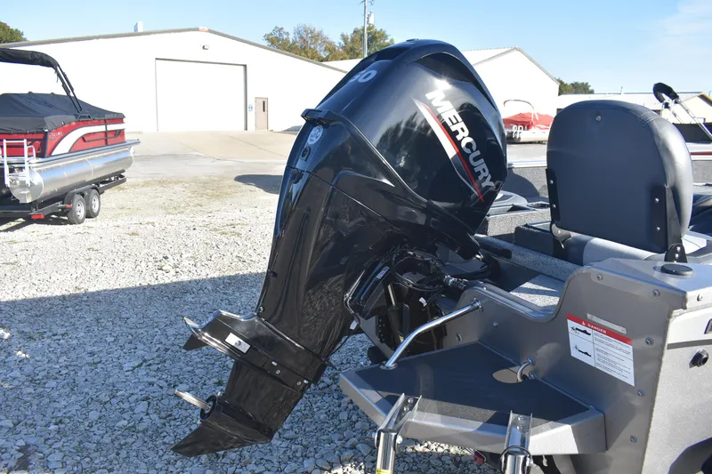 Slide: The Image of 2026 Lowe Fishing Machine 1675SC with Mercury outboard motor in a boatyard. - 5