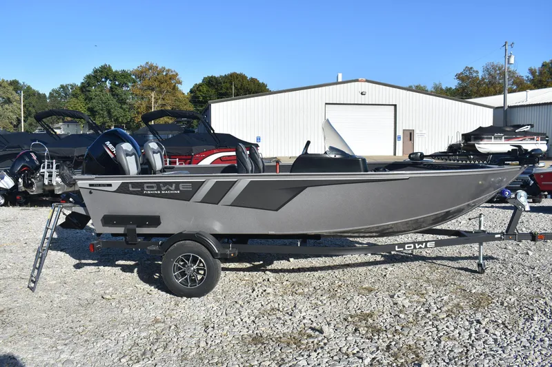 Slide: The Image of 2026 Lowe Fishing Machine 1675SC boat on trailer, parked outdoors. - 6
