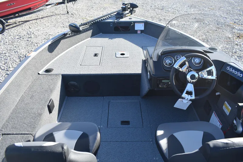 Slide: The Image of 2026 Lowe Fishing Machine 1675SC interior with steering console and seating. - 7