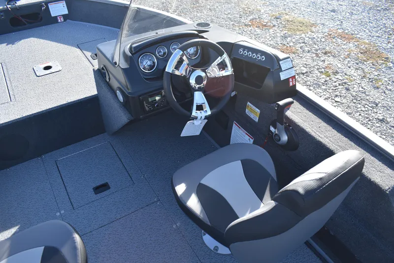 Slide: The Image of 2026 Lowe Fishing Machine 1675SC boat interior with steering wheel and seating. - 8
