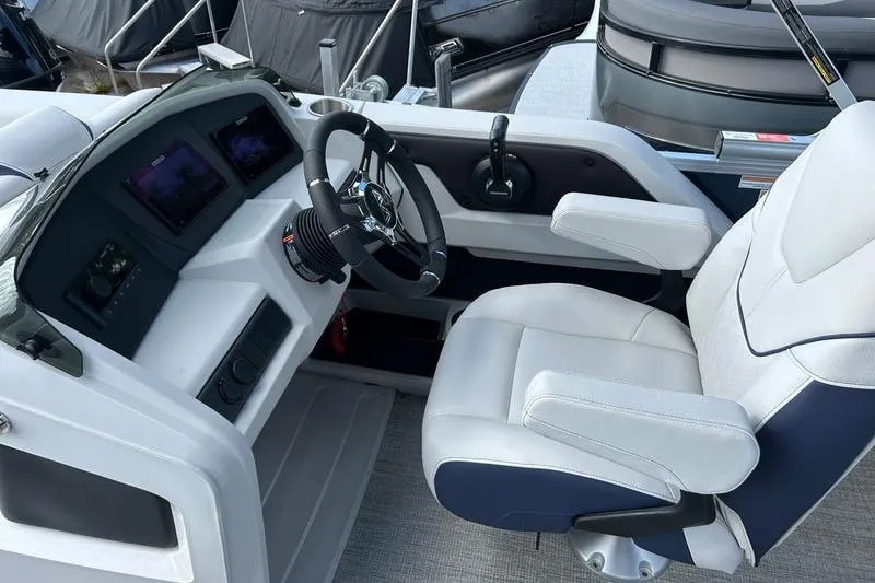 Slide: The Image of Interior of 2025 Avalon LSZ Quad Lounger Shift boat with modern steering console. - 2