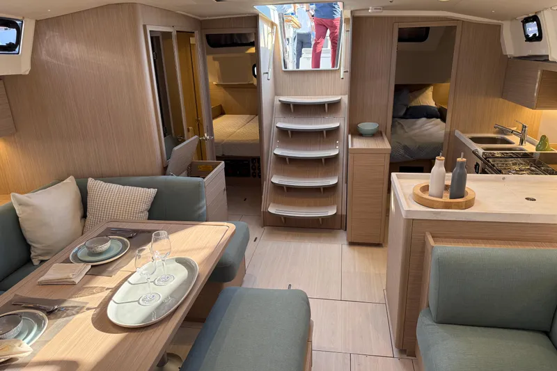 Slide: The Image of Luxurious interior of 2026 Beneteau Oceanis 47 yacht with modern dining and kitchen area. - 12