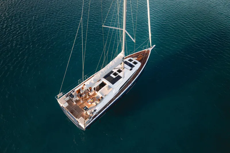 Slide: The Image of Aerial view of 2026 Beneteau Oceanis 47 sailboat on clear blue water. - 4