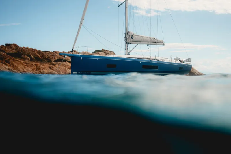 Slide: The Image of 2026 Beneteau Oceanis 47 sailboat near rocky shore, partially submerged view. - 5