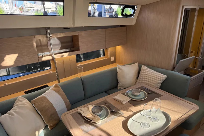 Slide: The Image of Luxurious interior of 2026 Beneteau Oceanis 47 yacht with elegant dining setup. - 7