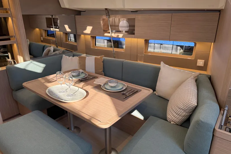Slide: The Image of Luxurious interior of 2026 Beneteau Oceanis 47 yacht with elegant dining setup. - 8