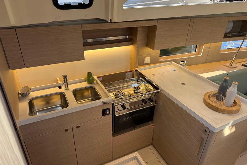 Slide: The Image of Modern kitchen interior of 2026 Beneteau Oceanis 47 yacht with sleek wood cabinetry. - 9