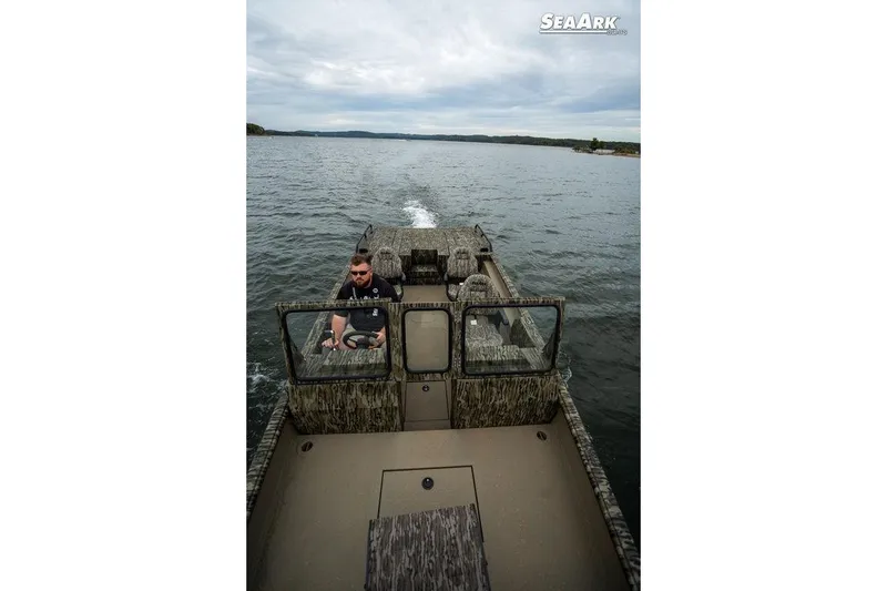 Slide: The Image of 2026 SeaArk Predator boat on water, featuring camouflage design and dual consoles. - 7