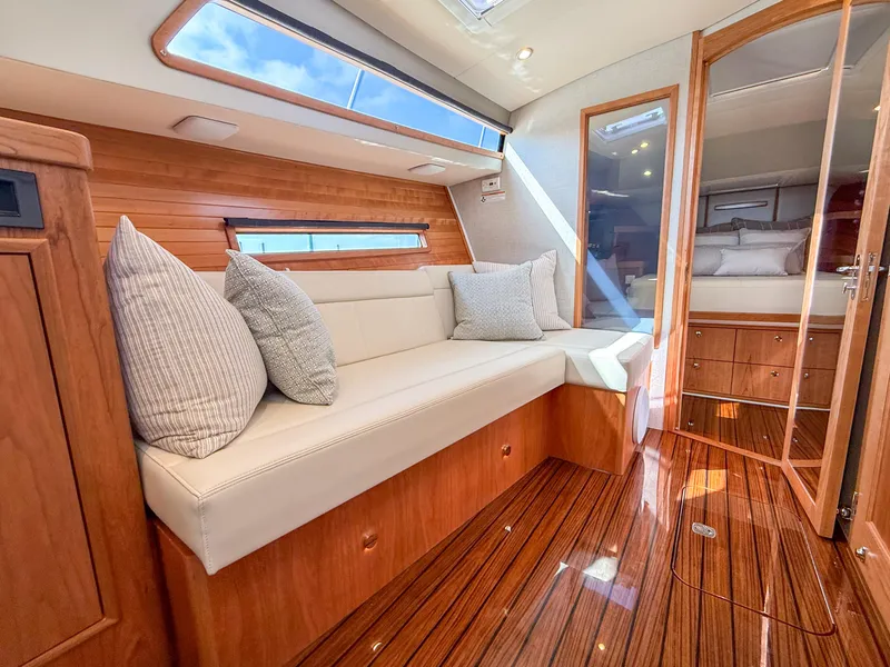 Slide: The Image of Luxurious interior of 2026 MJM 47R yacht with elegant wood finishes and plush seating. - 11