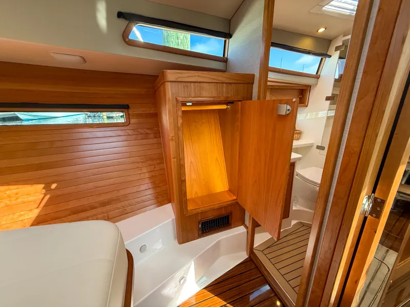 Slide: The Image of Luxurious 2026 MJM 47R yacht interior with wooden cabinetry and modern amenities. - 15